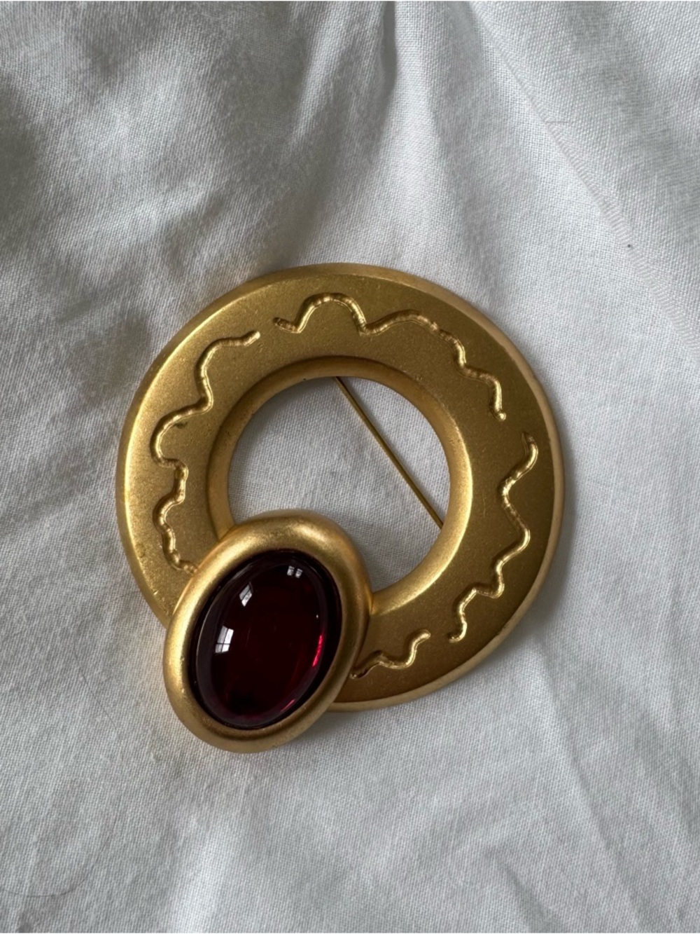 Monet Gold-Tone Circle Brooch with Deep Red Cabochon
